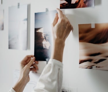 person placing pictures in a wall